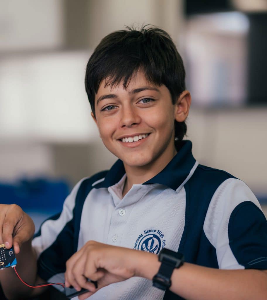 Duncraig Senior High student looks directly at camera while holding a piece of electronics equipment